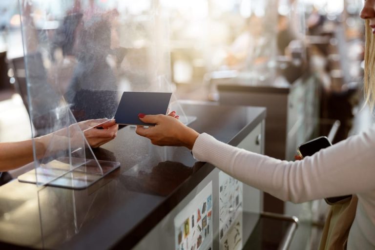 Hand handing out a passport